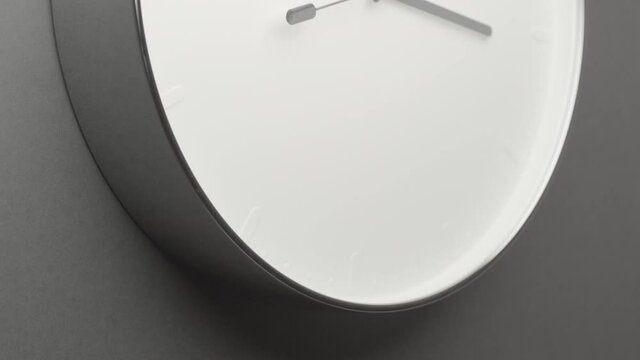 Clock Face on Dark Grey Office Wall in Timelapse