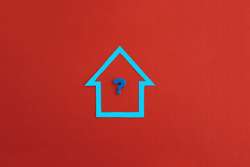Fototapeta na wymiar The question mark inside the house is blue on a red background. Determination of the value of the property, real estate valuation.