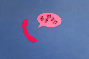 A telephone receiver, an oval for text, notes of red color on a blue background. The concept of transmitting messages and information.
