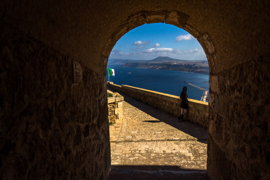 Lonely woman looking at the horizon at Fort Santa Cruz, one of the three forts in the city of Oran, the second largest port city of Algeria above the Gulf of Oran