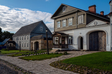 Fototapeta premium View of historical merchant buildings of estates on the main street of Izborsk Pechorskaya Street on a summer sunny day, Izborsk, Pskov region, Russia