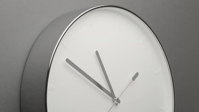 Clock Face on Dark Grey Office Wall in Timelapse