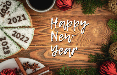 Card with festive cake decorated with numbers denoting the years 2020, 2021, 2022, 2023 made of chocolate and the inscription Happy New Year. Top view
