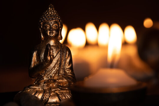 image in Buddhist temple next to candles
