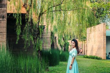 Beautiful Asian woman walking in the garden with sun light in evening.