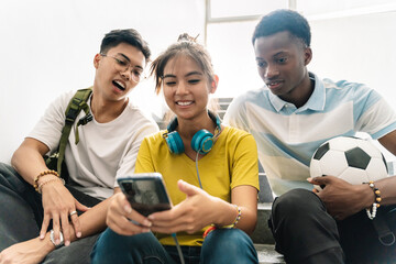 Teenager multiracial School friends watching smartphone together in the School Staircase