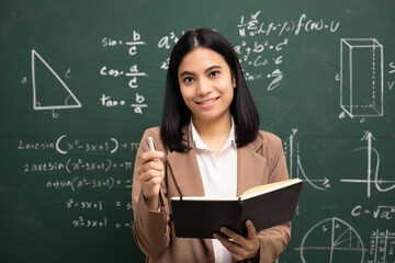 Young asian teacher woman teaching holding book and video conference with student looking camera....