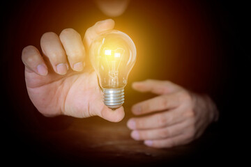 Creative new idea. The man is holding a light bulb.