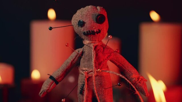 Voodoo Magic concept. Witchcraft with rag doll. Close-up of puppet nipped with needles.