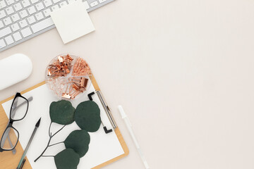 Office desk table top view with office supply, beige table with copy space, beige color workplace composition, flat lay