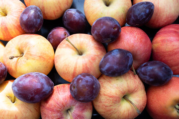 Above view of fresh fruits: apples and plums