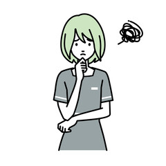 立って手をあごにあてて困っているエステ店員の女性