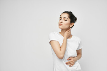 Fototapeta premium woman in a white t-shirt pain in the neck health problems