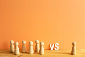 Majority vs minority concept. Wooden human figure on desk. orange background - obrazy, fototapety, plakaty