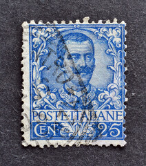 Cancelled postage stamp printed by Italy, that shows portrait of king Victor Emanuel, circa 1901.