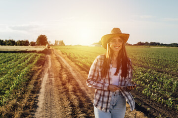 woman farmer walking outdoor in field - obrazy, fototapety, plakaty