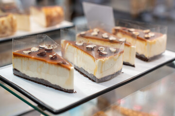 cheesecake on display, a showcase with cakes чизкейк на витрине, витрина с пирожными