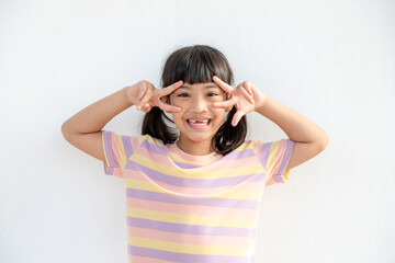 Portrait of surprised cute little toddler girl child over white background. Looking at the camera.