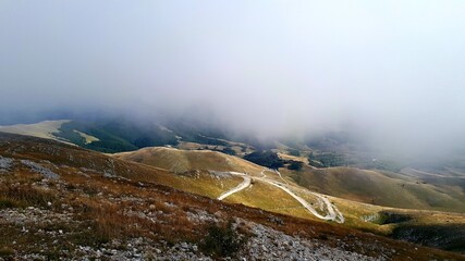 Mountain Bjelasnica landscape with the fog above gravel road, Bosnia and Herzegovina