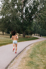 Asian woman going for a run outside along a path