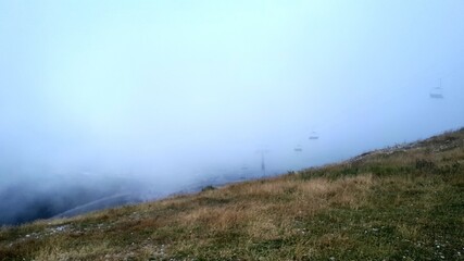 Misty morning on the mountain Bjelasnica, view from peak, cable cars in the fog, Bosnia and Herzegovina