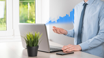 Business man holding tablet and showing holographic graphs and stock market statistics gain profits. Concept of growth planning and business strategy. Display of good economy form digital screen.