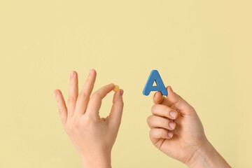 Woman with pill and letter A on color background