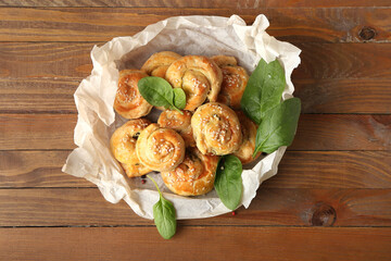 Puff pastry stuffed with spinach on wooden background