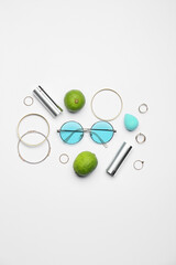 Set of female accessories and limes on white background