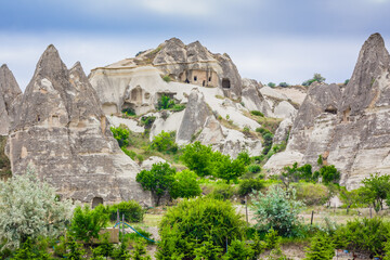 Fototapeta na wymiar Amazing Volcanic rock formations known as Love Valley or Fairy Chimneys in Cappadocia, Turkey. Mushroom Valley one of attractions in Goreme National Park, Turkey. Mountains with rooms inside