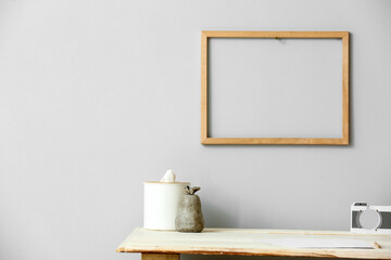 Modern workplace with tissue box near light wall