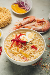 Bowl of tasty Thai soup on table