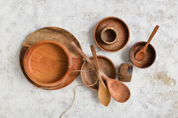 Different wooden tableware on light background