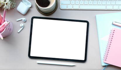 Above view woman workspace with digital tablet, stylus pen, coffee cup earphone and notebook on...
