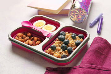 Lunch box with tasty food on light background
