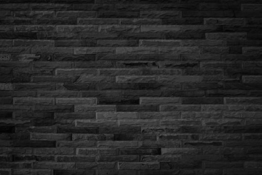 black brick wall for background and design. Dark sandstone wall texture and background with high resolution, pattern of stone brick wall.