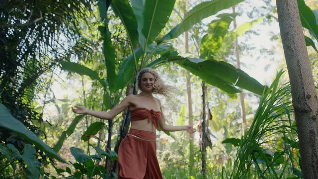 happy woman dancing in forest enjoying nature dance in lush tropical jungle 4k