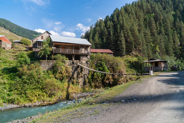 Hanging bridge on a mountain river in the village. Tusheti. Georiga