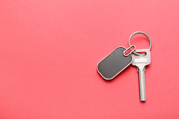 Key with stylish keychain on color background