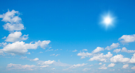 Naklejka na ściany i meble Blue sky with clouds and sun.
