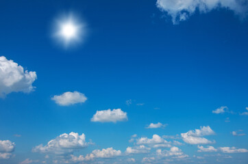 Blue sky with clouds and sun.