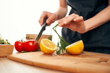 slicing lemon on a cutting board kitchen vegetables cooking