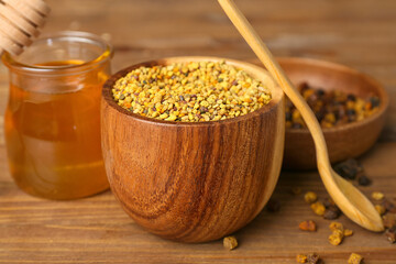 Bowl of bee pollen on wooden background