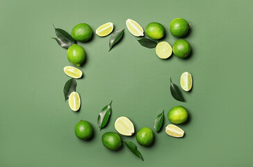 Frame made of tasty limes on color background