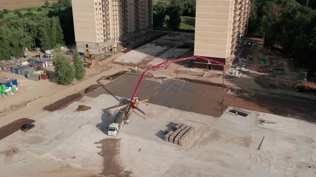 Aerial view - road construction site and a big pump for concrete pouring road
