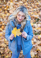 Time to relax. autumn fashion and beauty. pretty girl has long curly blond hair. lady in fall...