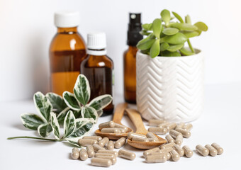 Vitamine capsules and oils on a white background