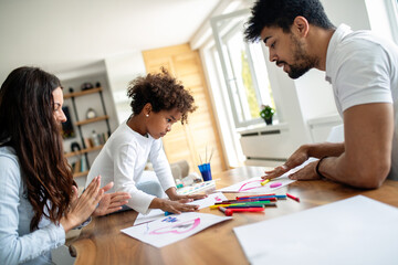 Obraz premium Happy multiethnic family spending time together at home. Parent child education fun concept