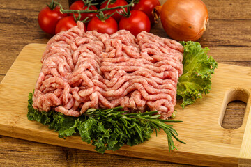 Raw pork minced meat over board