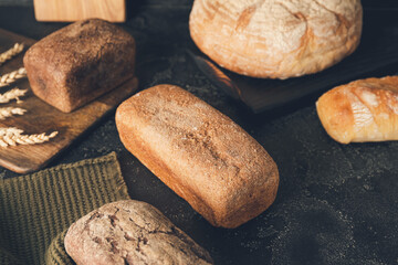 Assortment of fresh bread on dark background